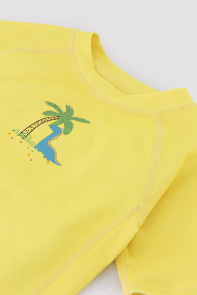Camiseta de baño bebé dibujo dinosaurio y palmera amarillo Ysabel Mora