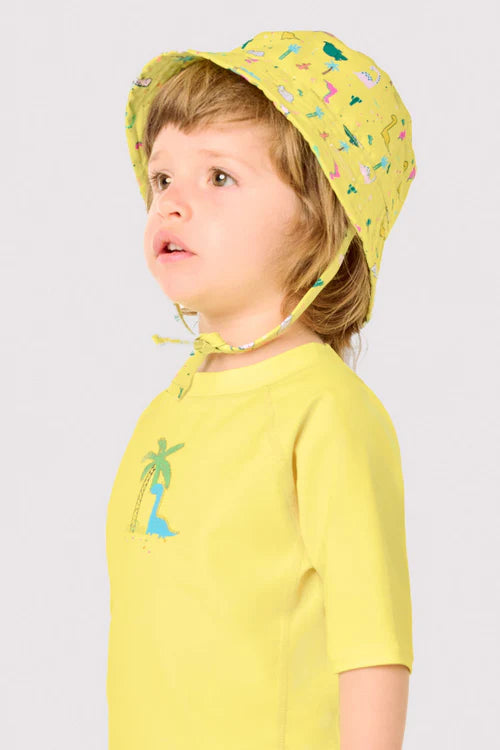 Gorro de playa bebé ala recta estampado dinosaurios Ysabel Mora