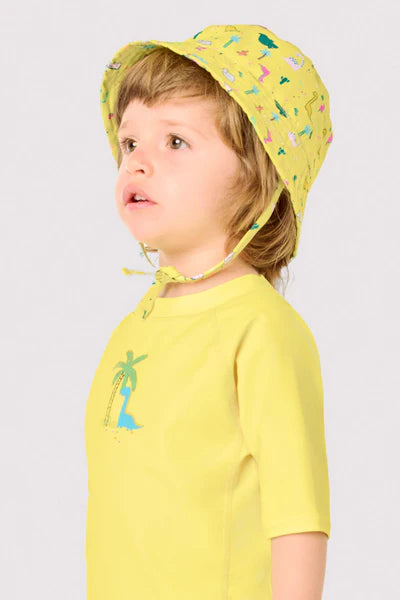 Camiseta de baño bebé dibujo dinosaurio y palmera amarillo Ysabel Mora