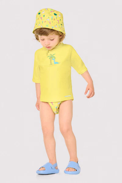 Camiseta de baño bebé dibujo dinosaurio y palmera amarillo Ysabel Mora